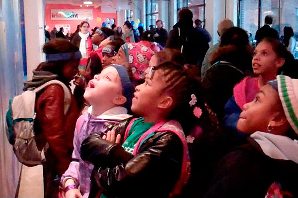 children in looking in awe at the science illustration process exhibit, Iridescent-ONR STEM Design Studio, Bronx, NY