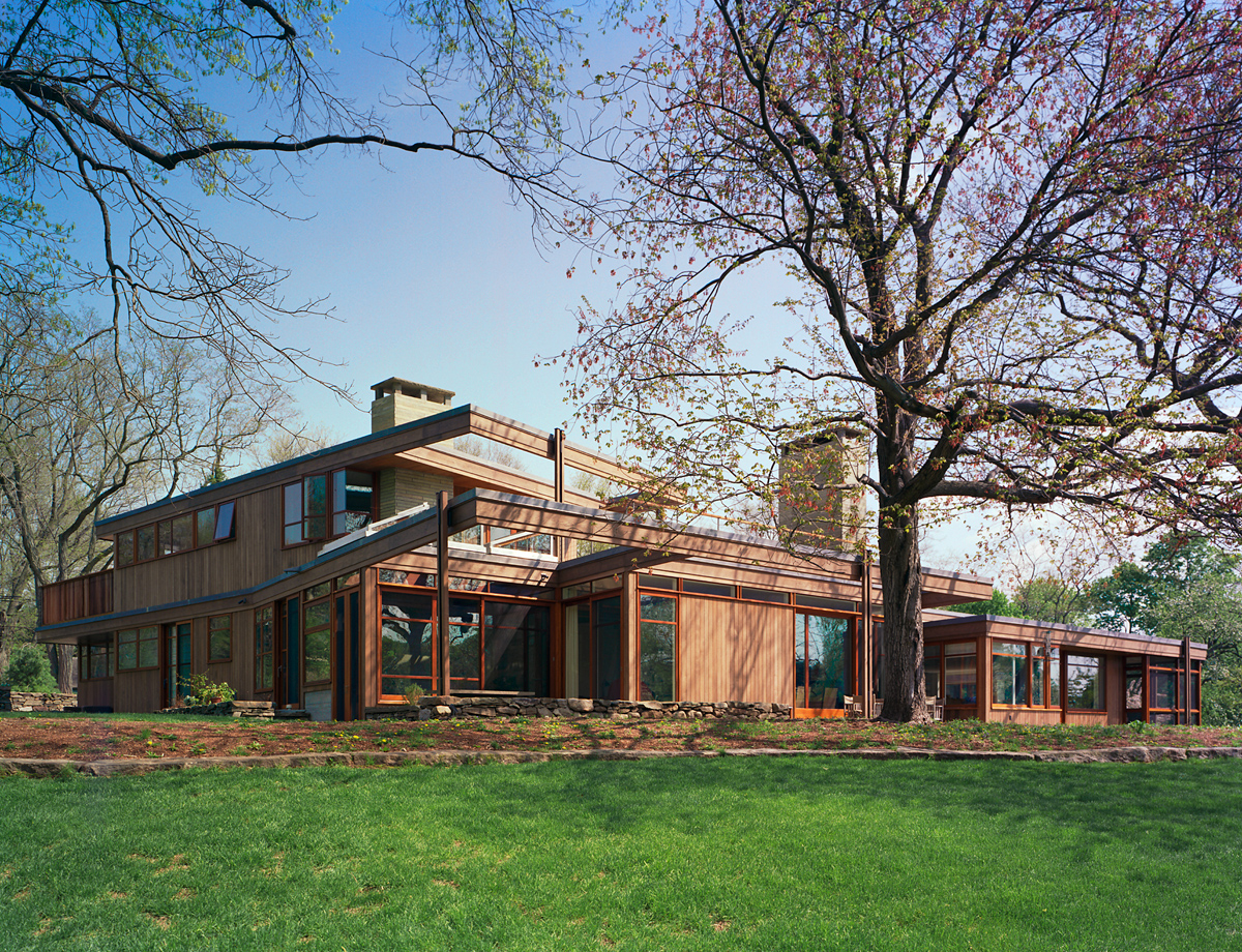 back view, wood-clad modern house opening up to nature, Greater Boston, MA