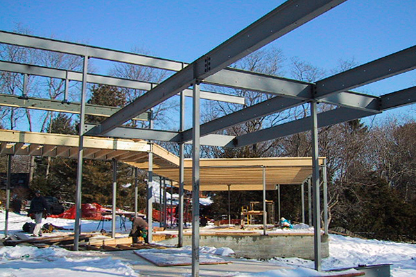 construction photo showing steel and wood frame of modern house, Greater Boston, MA