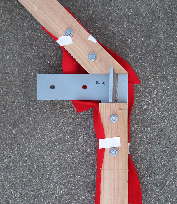 Partly assembled wood joint shows complex steel plate assembly