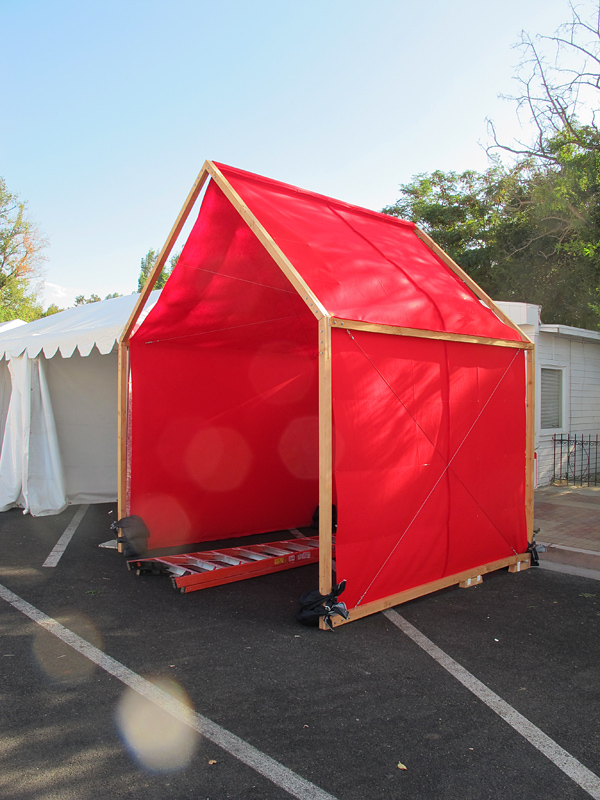 Red felt and cedar, mobile, temporary pavilion installation for showcasing art at festivals