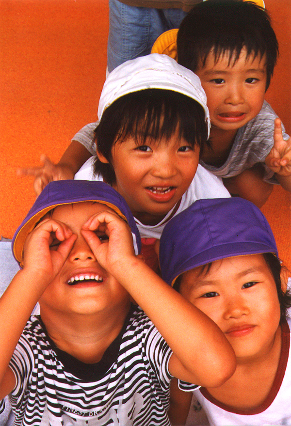 4 kindergarten children making faces for the camera, Oshio, Japan