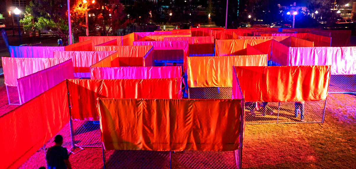 maze-like art installation aerial with colored lights at night