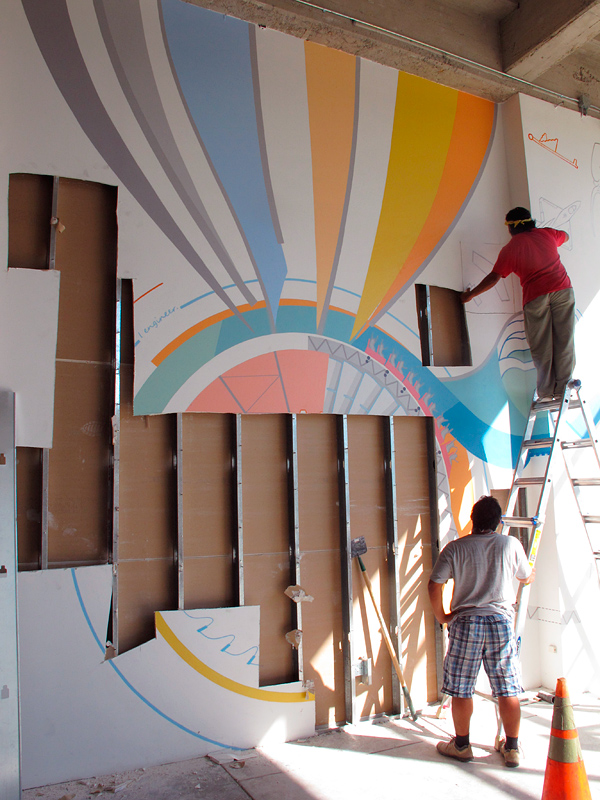 cutting down the science and engineering mural at Iridescent's STEM education studio, Los Angeles