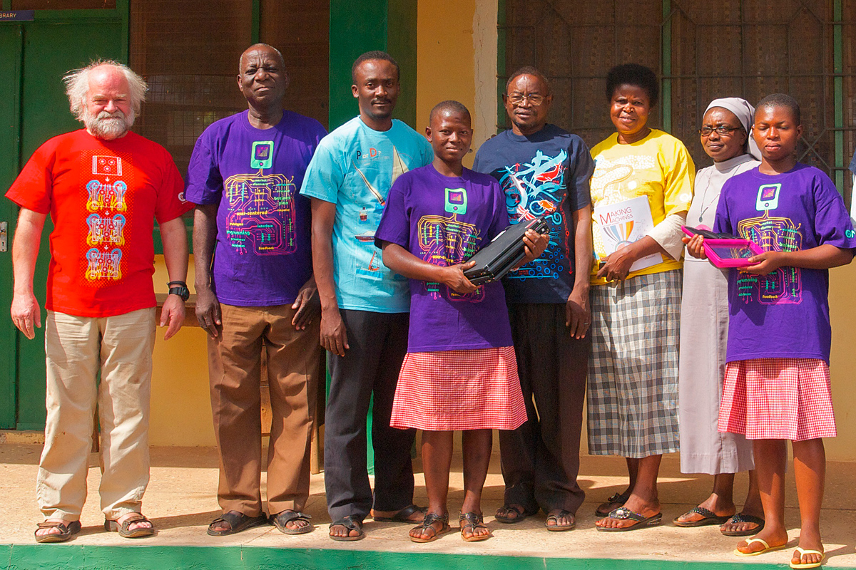 students and staff in Ghana wearing Ioana's science T-shirts designed for Iridescent