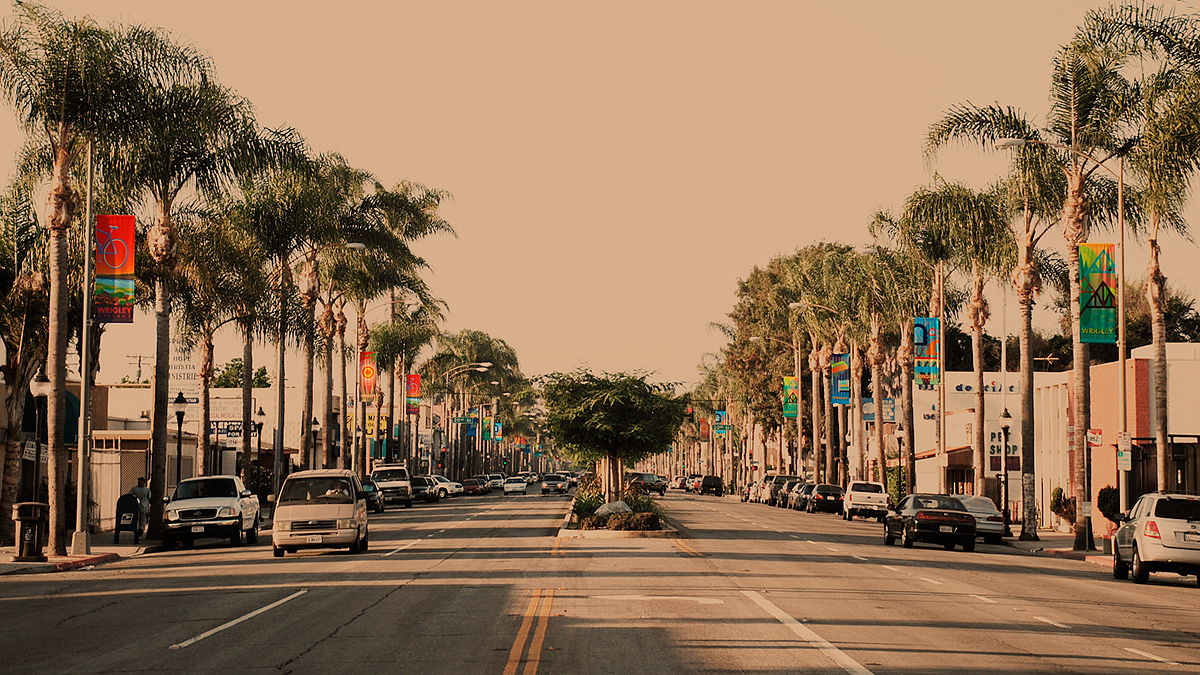 vintage/sepia tone  photo with street banners in bright colors along Pacific Ave, Wrigley Village, Long Beach, CA